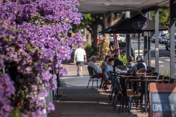 purple flowers and people dining along Racecourse Road
