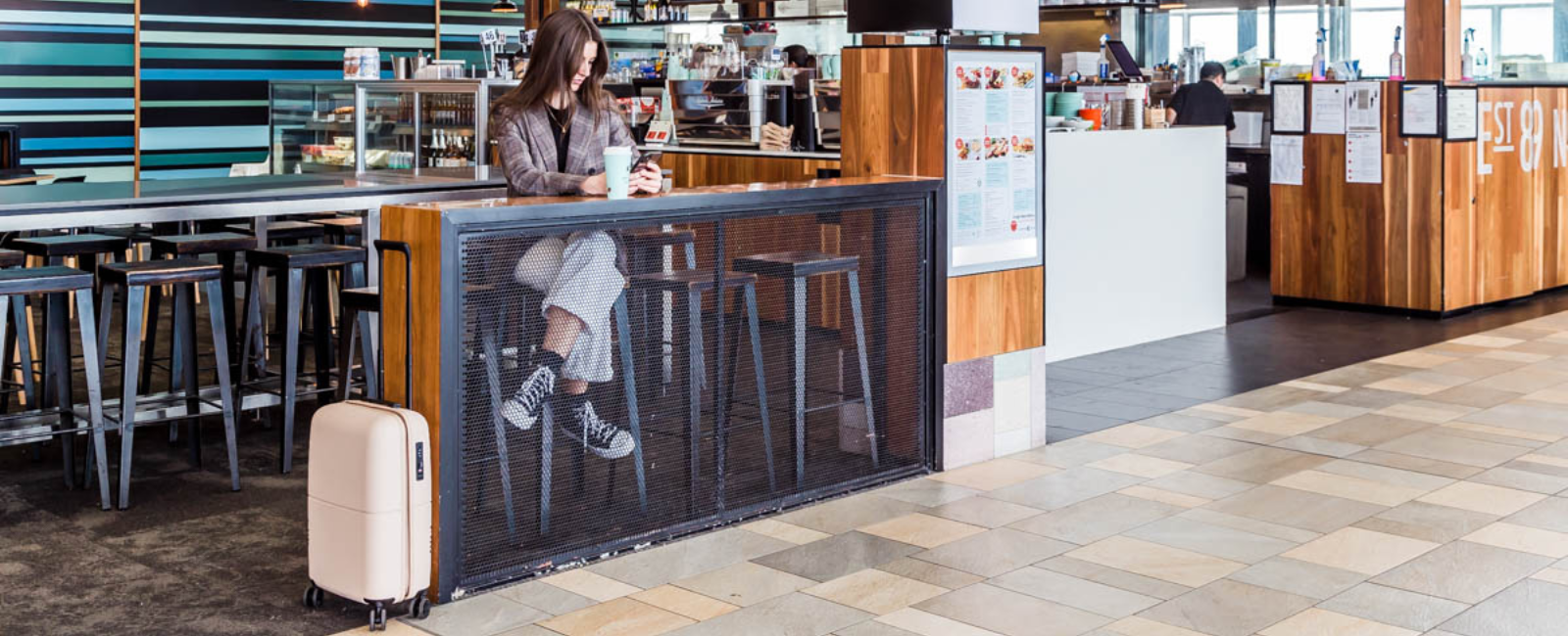 Traveller with suitcase at The Coffee Club